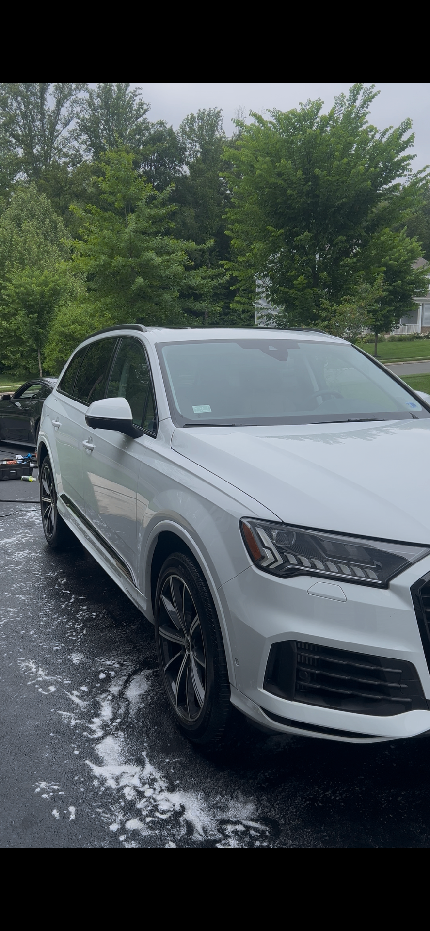 Detailed white Audi SUV parked after a wash